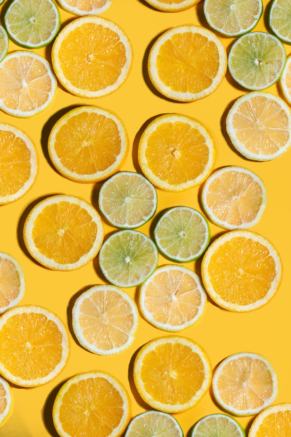 Assorted Citrus Fruit Slices on Yellow Background